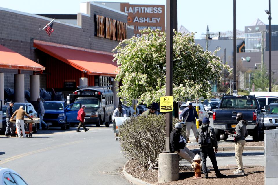 Day laborers stand outside The Home Depot parking lot in New Rochelle April 22, 2024.