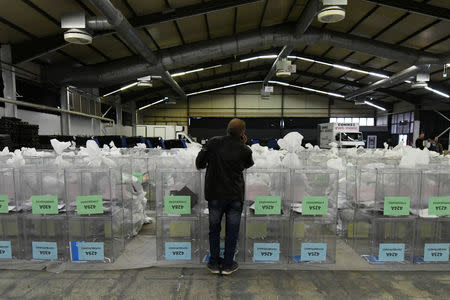 A man stands next to ballot boxes and electoral material to be used in the upcoming European and local elections in Thessaloniki, Greece, May 24, 2019. REUTERS/Alexandros Avramidis