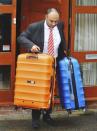 A man carries luggage from the home of former England soccer manager Sam Allardyce, in Bolton, Britain September 28, 2016. REUTERS/Chris Neill