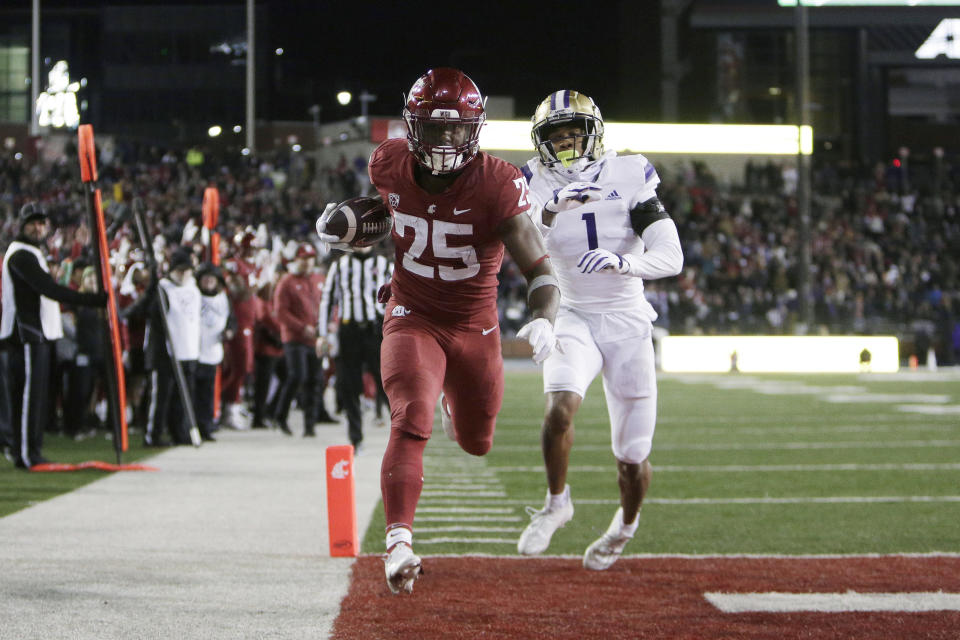 Washington State running back Nakia Watson (25) runs for a touchdown while defended by Washington cornerback Jordan Perryman (1) during the first half of an NCAA college football game, Saturday, Nov. 26, 2022, in Pullman, Wash. (AP Photo/Young Kwak)