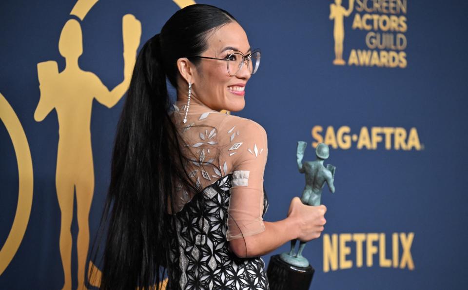 Actress Ali Wong shows off her award for Outstanding Performance by a Female Actor in a Television Movie or Limited Series for 'Beef' during the 30th Annual Screen Actors Guild awards at the Shrine Auditorium in Los Angeles, Feb. 24, 2024.