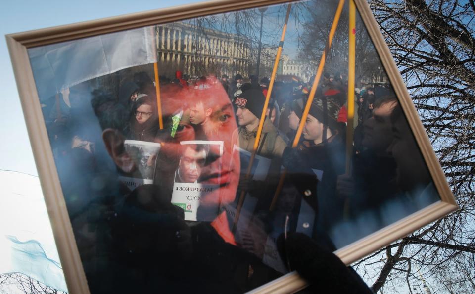 Protesters are reflected in the frame of a portrait during a rally in memory of opposition leader Boris Nemtsov in St. Petersburg, on February 29.