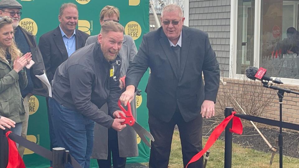 The Botanist Connecticut Operations General Manager Ben Tinsley and Montville Mayor Ron McDaniel (at the front) cut the ribbon symbolizing the start of adult-use cannabis sales.