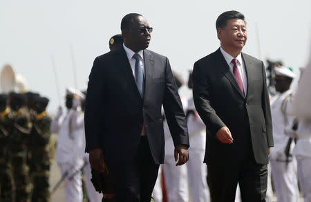 Chinese President Xi Jinping walks with Senegal's President Macky Sall after arriving at the Leopold Sedar Senghor International Airport, at the start of his visit to Dakar, Senegal July 21, 2018. REUTERS/Mikal McAllister