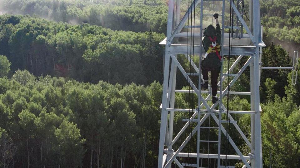 Kimberly Jackson climbs a fire tower in this undated photo.  According to Krenzman, observers can spend 10-12 hours on the summit, depending on the fire danger of the day.