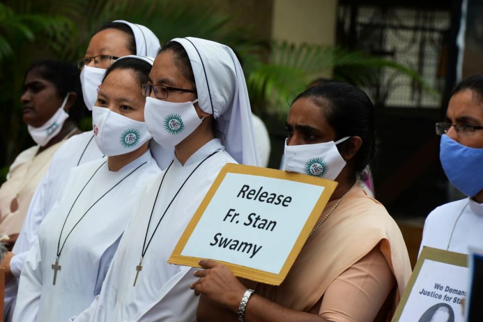 <div class="inline-image__caption"><p>Catholic nuns hold placards during a protest against the arrest of Father Stan Swamy.</p></div> <div class="inline-image__credit">Noah Seelam/AFP via Getty</div>