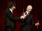 Rolling Stones Ron Wood and Charlie Watts (R) joke on the stage before the screening of their film 'Shine A Light' at the opening ceremony of the 58th Berlinale International Film Festival