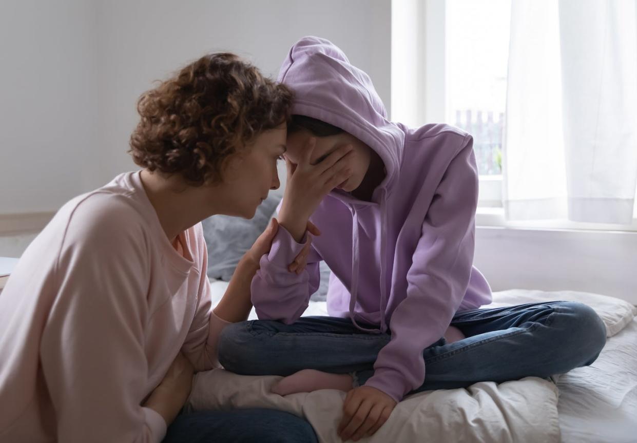 People who experience anxiety in childhood are more likely to deal with it in adulthood too. <a href="https://www.gettyimages.com/detail/photo/worried-mom-comforting-depressed-teen-daughter-royalty-free-image/1221847312?phrase=anxiety%20kids&adppopup=true" rel="nofollow noopener" target="_blank" data-ylk="slk:fizkes/iStock via Getty Images Plus;elm:context_link;itc:0;sec:content-canvas" class="link ">fizkes/iStock via Getty Images Plus</a>