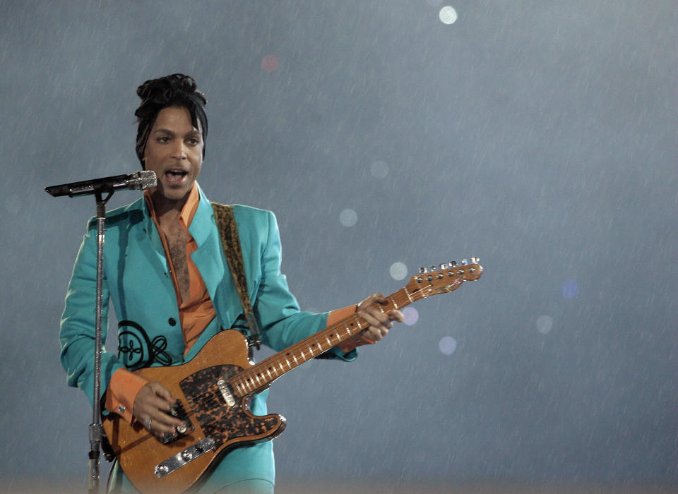 Wearing an aqua tailored suit, Prince performs during half-time show 04 February 2007 