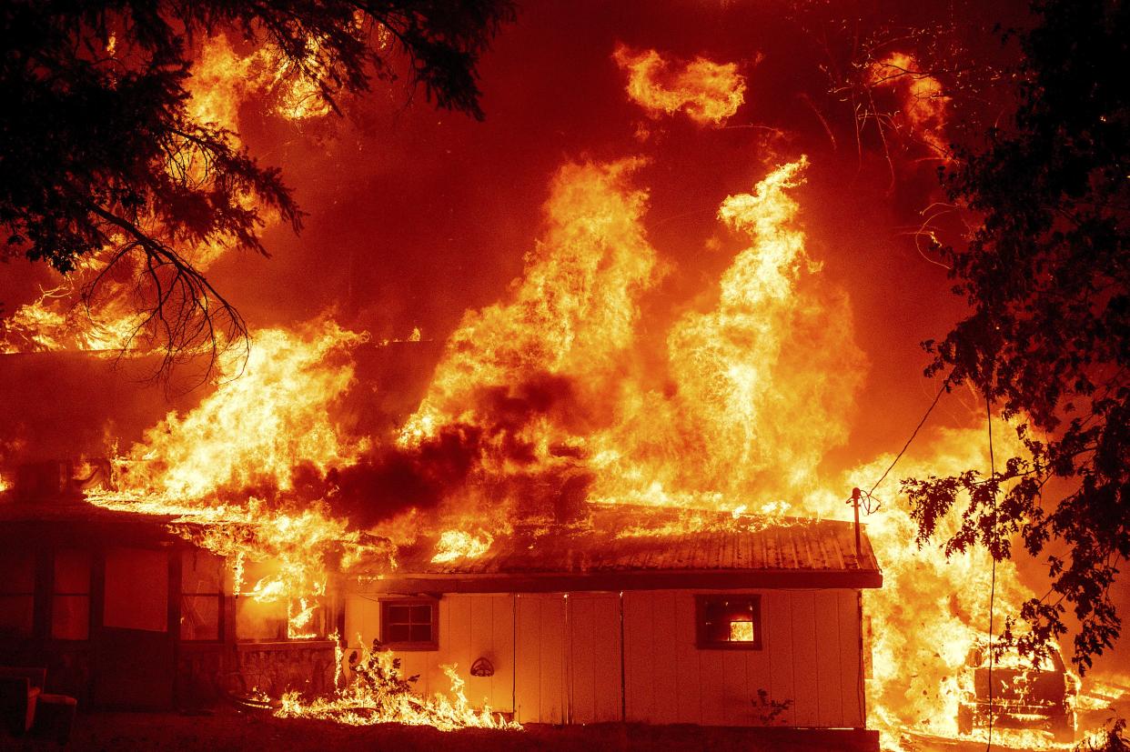 Flames consume a home as the Dixie Fire tears through the Indian Falls community in Plumas County, Calif. on Saturday, July 24, 2021. The fire destroyed multiple residences in the area.