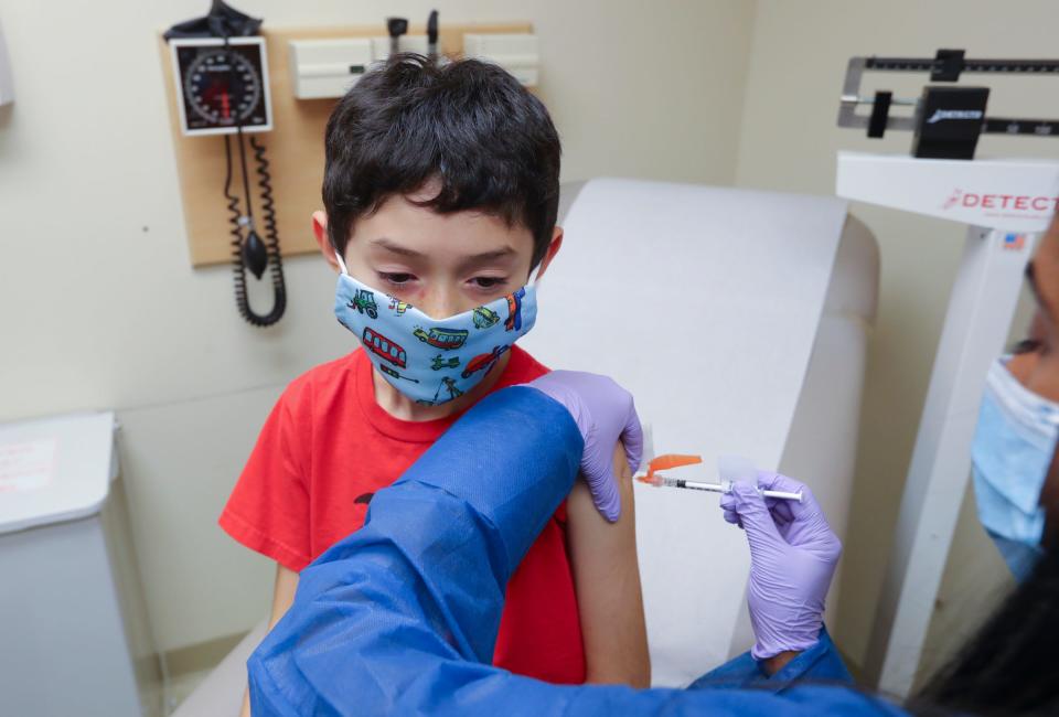 Public Health Nurse Nisha Kurian, right, administers the COVID-19 vaccine to Juan Jose Silva-Lopez at the Westchester County Department of Health office in White Plains on Wednesday, November 10, 2021.