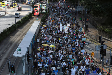 Demonstrators march in protest of the jailing of student leaders Joshua Wong, Nathan Law and Alex Chow, who were imprisoned for their participation of the 2014 pro-democracy Umbrella Movement, also known as "Occupy Central" protests, in Hong Kong China August 20, 2017. REUTERS/Tyrone Siu