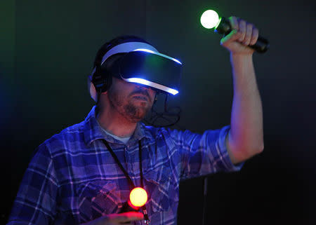 A man plays a demo game on a Sony "Project Morpheus" virtual reality system at the 2014 Electronic Entertainment Expo, known as E3, in Los Angeles, June 10, 2014. REUTERS/Jonathan Alcorn