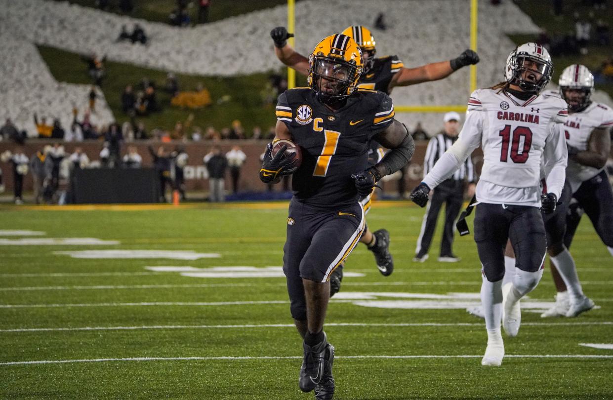 Missouri Tigers running back Tyler Badie (1) runs in for a touchdown as South Carolina Gamecocks defensive back R.J. Roderick (10) looks on during the second half Saturday at Faurot Field.