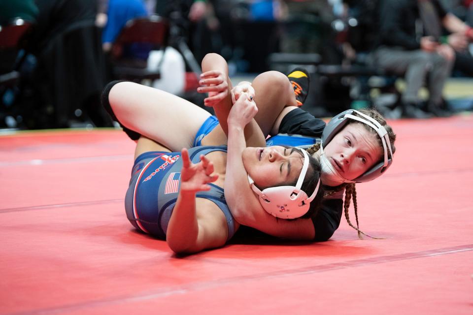 Pueblo Central's Kenna Pino earns backpoints on Aryah Quintanilla of Fountain-Fort Carson during their 135-pound first round matchup in the girls wrestling state tournament at Ball Arena on Thursday, Feb. 16, 2023.