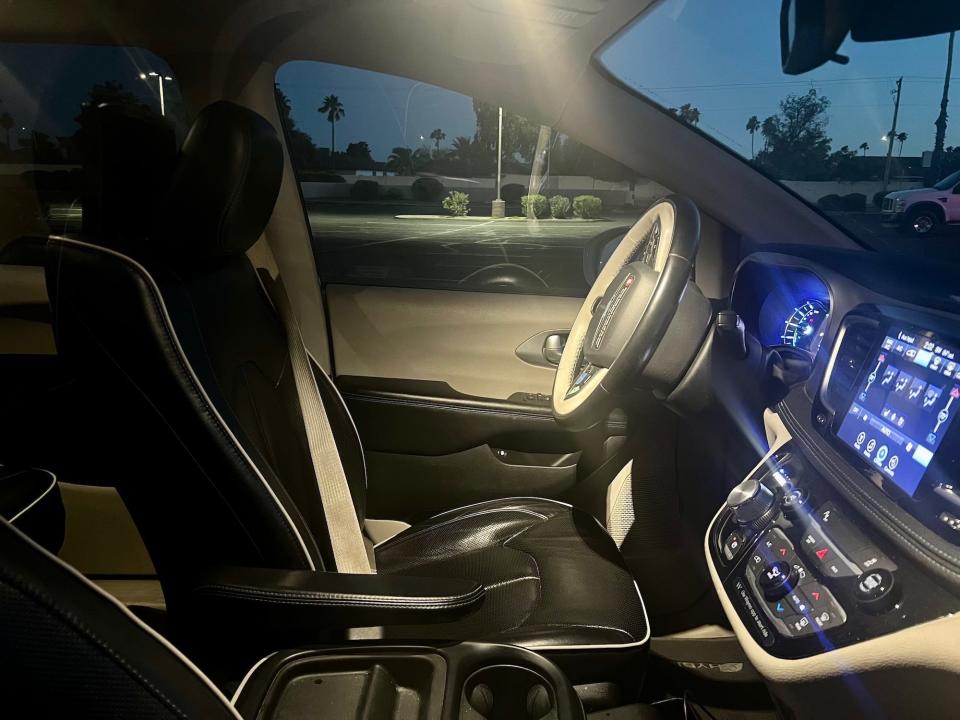 The empty driver's seat in the Waymo car.