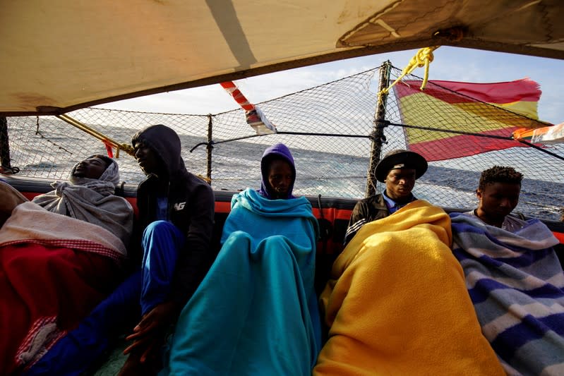 Migrants rest on board of NGO Proactiva Open Arms rescue boat in central Mediterranean Sea