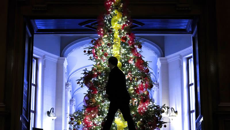 A person walks past a Christmas tree at Queen’s Park in Toronto on Wednesday, Dec. 6, 2023. 