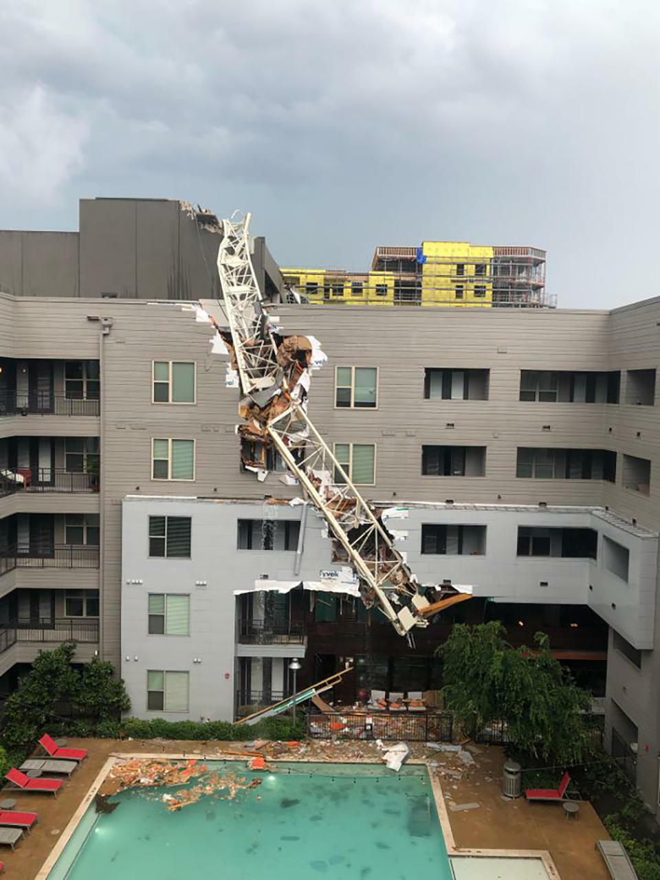 This photo provided by Michael Santana shows the scene after a crane collapsed into Elan City Lights apartments in Dallas amid severe thunderstorms Sunday, June 9, 2019. (Michael Santana via AP)