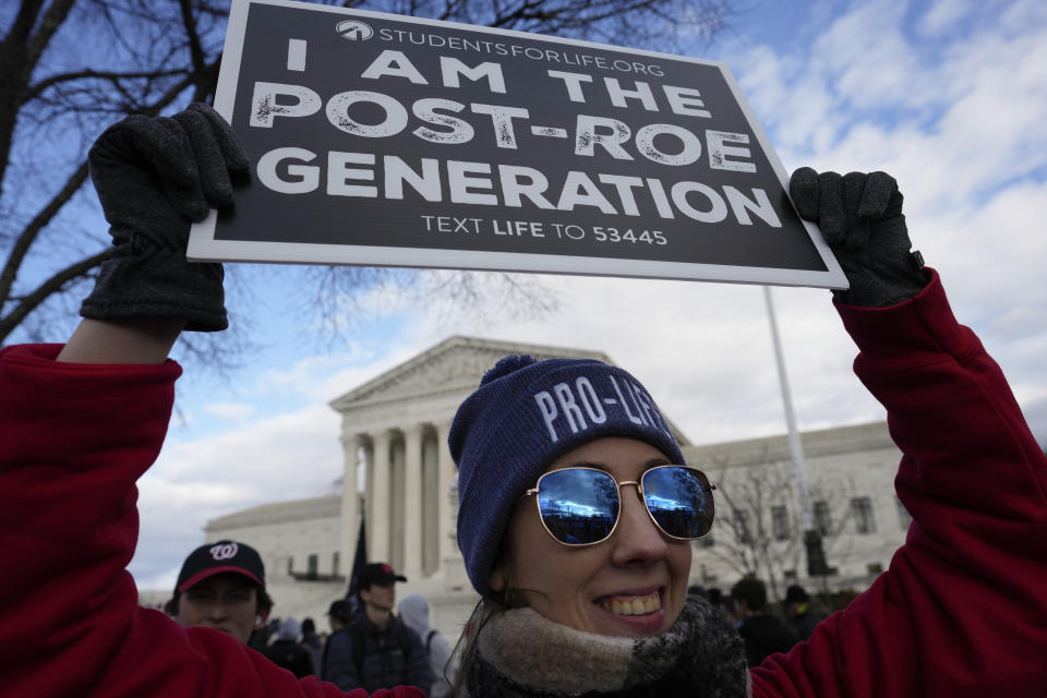 With the U.S. Supreme Court in the background, an anti-abortion demonstrator holds a sign during the March for Life, Friday, Jan. 20, 2023, in Washington. (AP Photo/Alex Brandon)