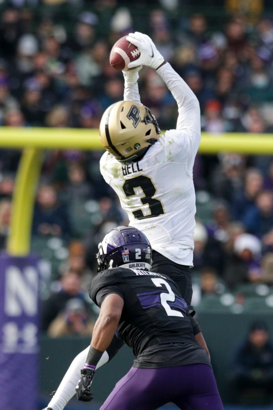 Purdue wide receiver David Bell (3) makes a catch above Northwestern defensive back Cameron Mitchell (2) during the third quarter of an NCAA college football game, Saturday, Nov. 20, 2021 at Wrigley Field in Chicago.