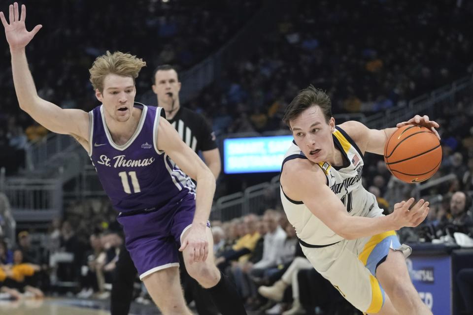 Marquette's Tyler Kolek drives past St. Thomas's Drake Dobbs during the first half of an NCAA college basketball game Thursday, Dec. 14, 2023, in Milwaukee. (AP Photo/Morry Gash)