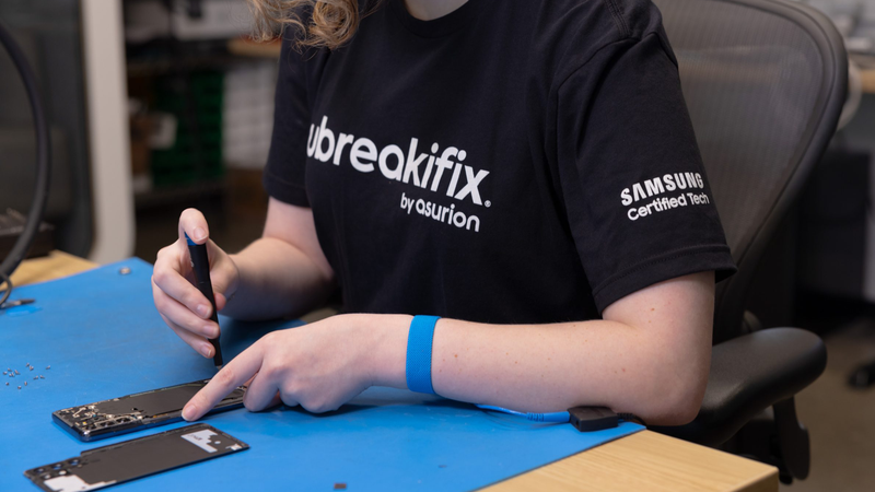 A photo of a person fixing a Samsung smartphone