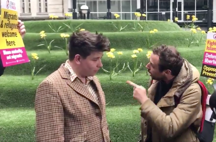 A Breitbart reporter (left) is confronted outside the Ukip event