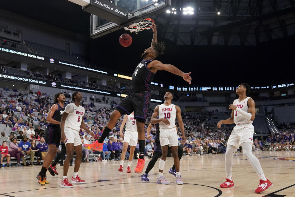 TCU center Eddie Lampkin Jr. (4) dunks as SMU's Jalen Smith (2), Zach Nutall (10) and Zhuric Phelps (1) watch during the first half of an NCAA college basketball game Saturday, Dec. 10, 2022, in Fort Worth, Texas. (AP Photo/Tony Gutierrez)