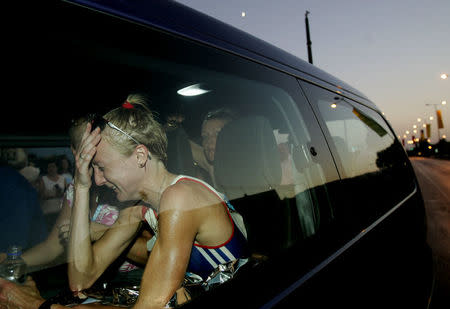 Britain's Paula Radcliffe cries in a vehicle after retiring from the women's marathon in the Athens 2004 Olympic Games in Greece August 22, 2004. REUTERS/Yannis Behrakis