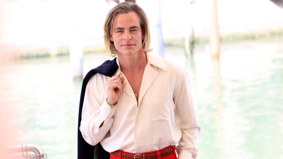 Pictured here in slouchy red, white and blue suiting, Pine attends the Venice International Film Festival on September 05, 2022. - Franco Origlia/Getty Images