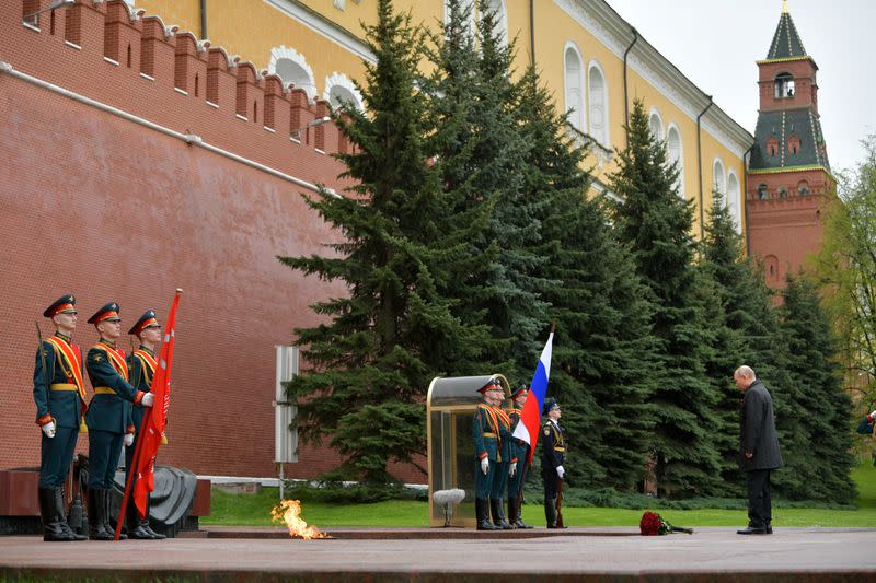 Russian President Vladimir Putin takes part in a flower-laying ceremony at the Tomb of the Unknown Soldier on Victory Day in central Moscow