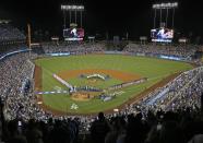 <p>Both teams stand on the baselines as the members of the Los Angeles Philharmonic, under the direction of famed composer John Williams, prepare to play the national anthem as Los Angeles Dodgers Hall of Fame broadcaster Vin Scully is honored in a ceremony before a baseball game against the Colorado Rockies at Dodger Stadium Friday, Sept. 23, 2016. (AP Photo/Reed Saxon) </p>