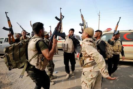 Members of Iraqi security forces celebrate after the liberation of Khalidiya village from Islamic State militants, south of Mosul, during an operation to attack Islamic State militants in Mosul, Iraq, October 20, 2016. REUTERS/Thaier Al-Sudani