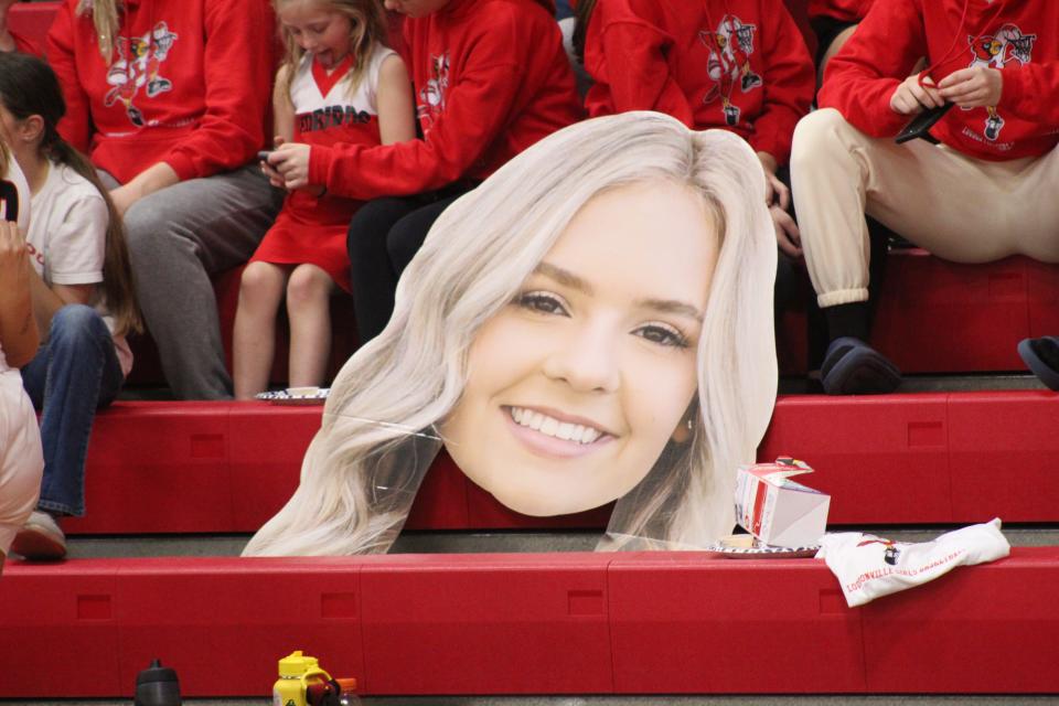 A cutout big face poster of Jena Guilliams at a Loudonville home game this season.