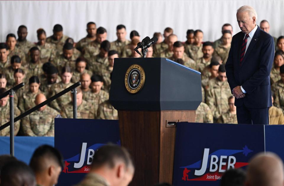 President Joe Biden bows his head during remarks to service members, first responds and their families at Joint Base Elmendorf-Richardson in Anchorage, Alaska, on the 22nd anniversary of the 9/11 terrorist attacks on New York and Washington.