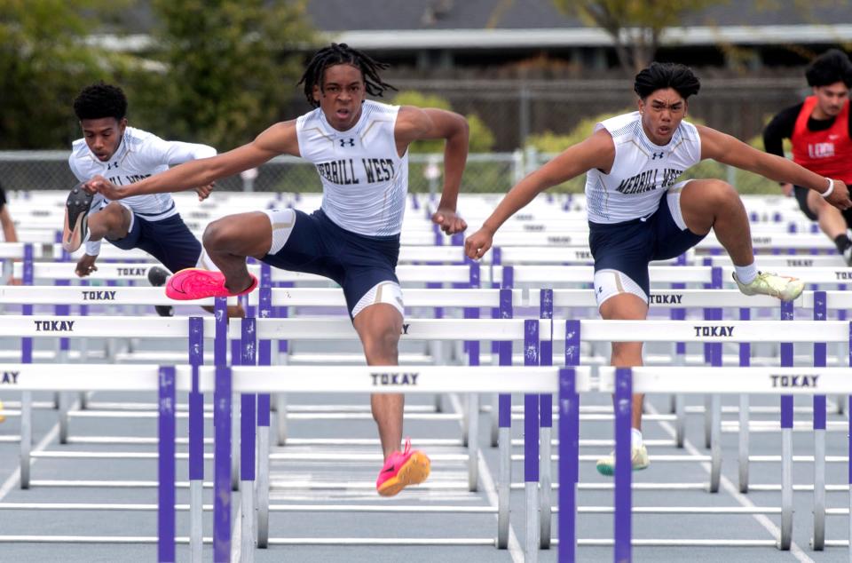 West's Marcel Bovell, left, Cam Williams and McKye Valdez finish 3rd, 1st and 2nd in the boys varsity 100 meter hurdles during a track meet at Tokay in Lodi on Thursday, Mar. 29, 2023. A fast shutter speed stops the action.