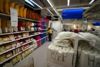 An employee arranges cushions inside IKEA's first city store in Mumbai