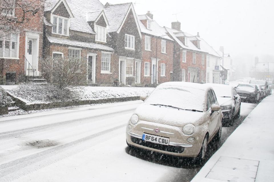 Cars parked during a snow flurry in Lenham, Kent, on Monday (PA)