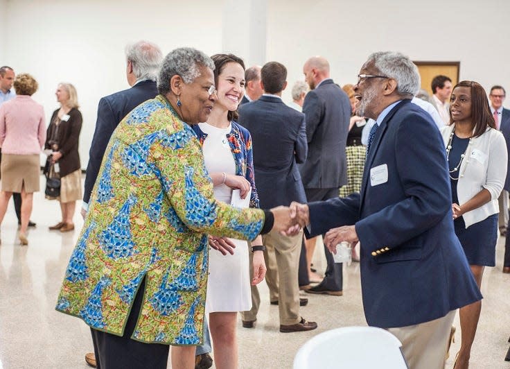 Judge Richard Dinkins, right, greets “Little Rock Nine” member Minnijean Brown-Trickey at a luncheon in 2015.