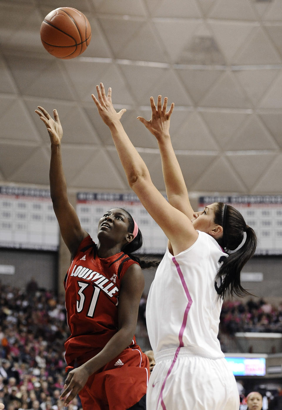 Louisville's Asia Taylor, left, shoots over Connecticut's Stefanie Dolson during the first half of an NCAA college basketball game on Sunday, Feb. 9, 2014, in Storrs, Conn. (AP Photo/Jessica Hill)