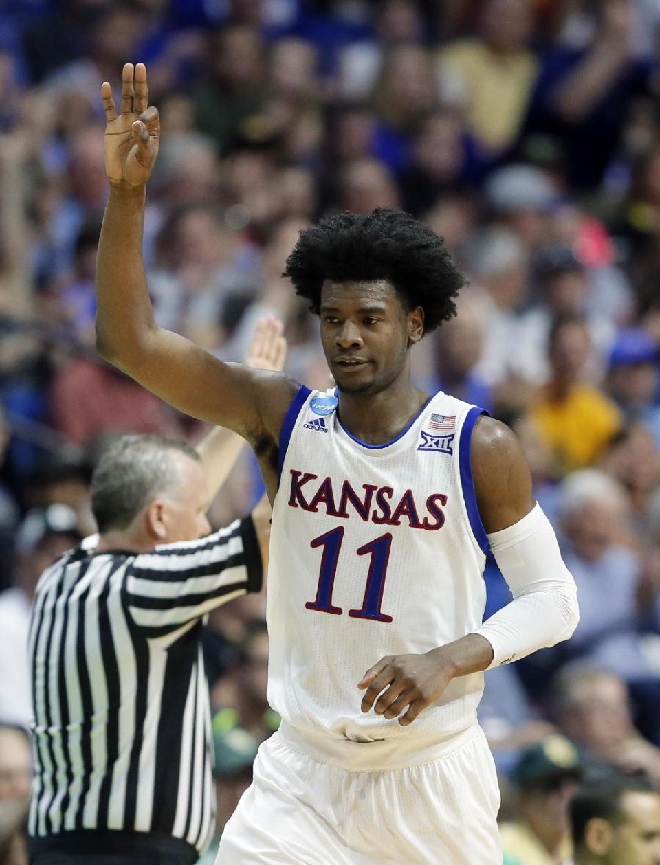 Kansas guard Josh Jackson (11) celebrates sinking a three-point basket against Michigan State in the first half of a second-round game in the men's NCAA college basketball tournament in Tulsa, Okla., Sunday, March 19, 2017. (AP Photo/Tony Gutierrez)