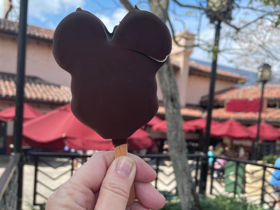 hand holding mickey ice cream bar at disney world