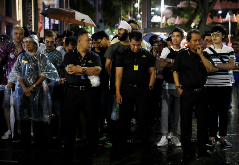 People queue overnight for iPhone X outside the Apple store in Singapore