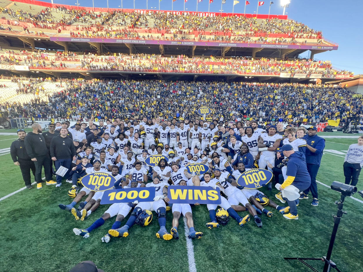 Michigan players celebrate the 1000th win in program history after their victory over Maryland. (Brad Mills-USA TODAY Sports)
