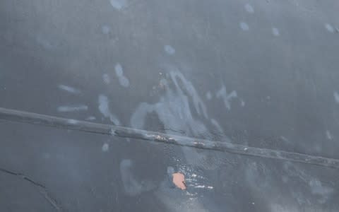 A U.S. military image shows what the Pentagon says is a handprint from an individual who removed an unexploded limpet mine from the side of the motor vessel M/T Kokuka Courageous - Credit: Reuters