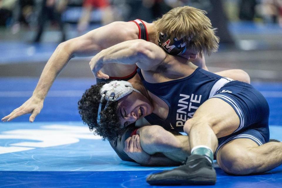 Beau Bartlett of Penn State grapples Kal Miller of the University of Maryland during the Men’s Division I NCAA Wrestling Championships at T-Mobile Center on Thursday, March 21, 2024, in Kansas City.