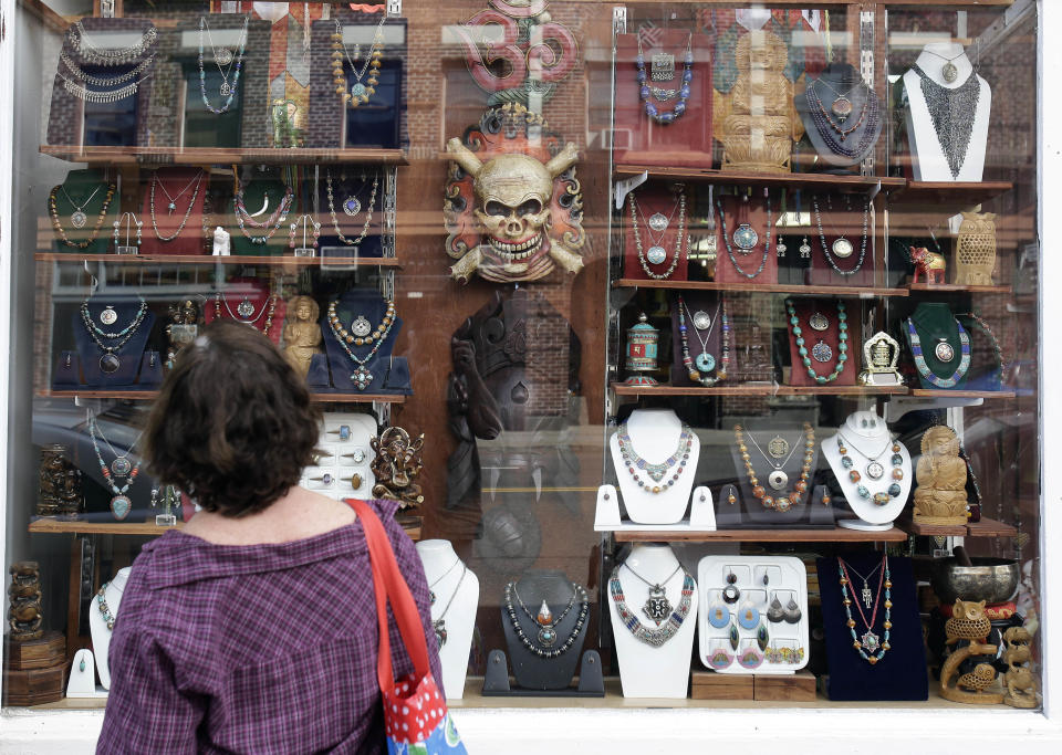This April 30, 2013, image shows a window-shopper looking at merchandise on display in a store on Hawthorne Boulevard in Portland, Ore. Hawthorne is known for its funky stores and vintage clothing shops, and is a great place for tourists to visit to soak up the people-watching scene. (AP Photo/Don Ryan)