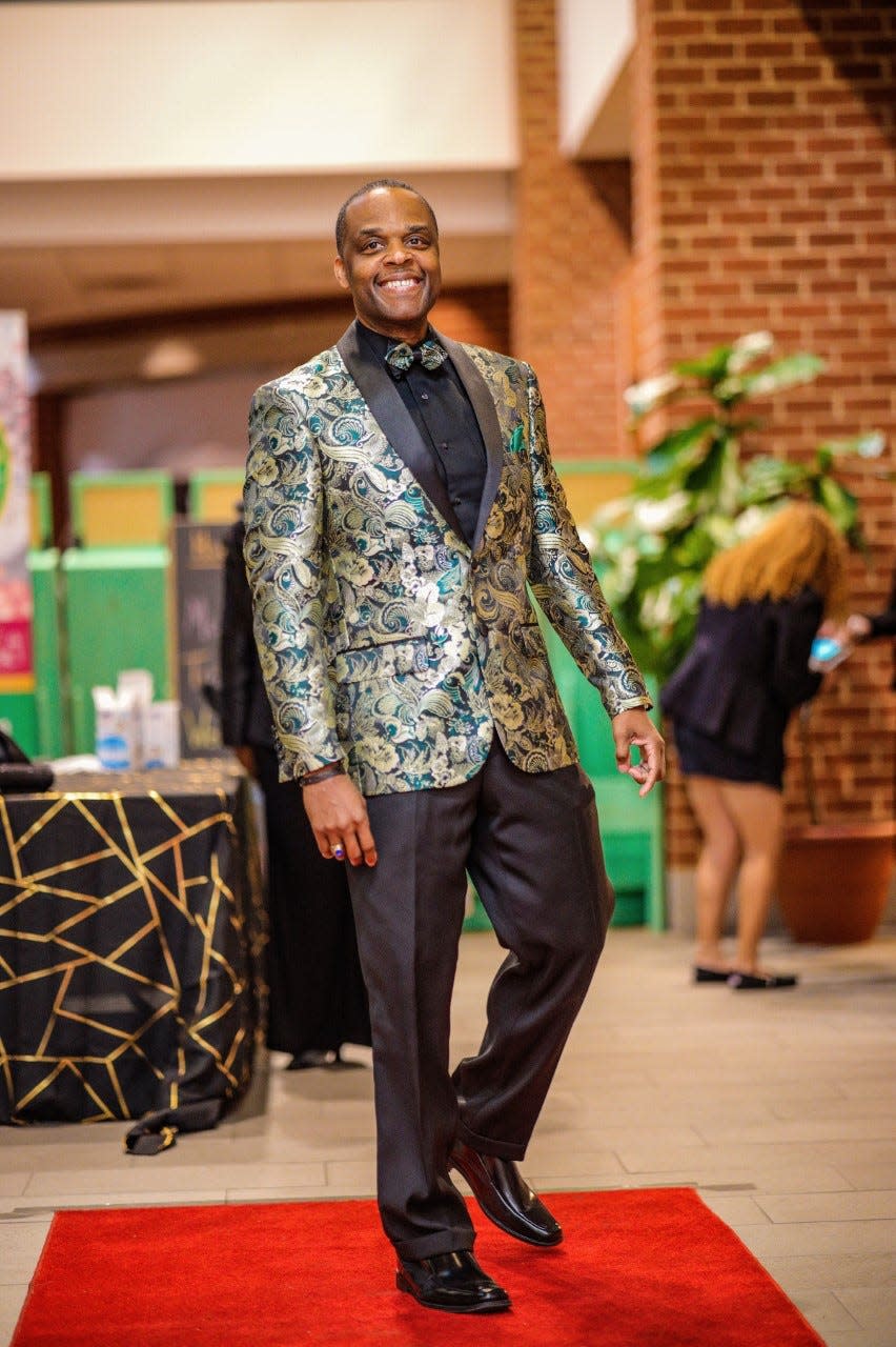 Pastor Shawn Brooks, founder and senior pastor of Greater Works Christian Fellowship, walks the red carpet at a benefit in Petersburg hosted by his brother DB Donamatrix and niece Tuesdae Donyale on March 31, 2023.