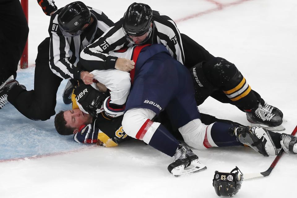 Boston Bruins' Charlie Coyle (13) and Washington Capitals' Dmitry Orlov fight during the second period in Game 4 of an NHL hockey Stanley Cup first-round playoff series Friday, May 21, 2021, in Boston. (AP Photo/Michael Dwyer)